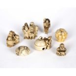 A group of four early 20th century Japanese ivory netsukes, one carved as a figure with a bell, 5cm;