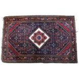 A Persian Baktiari style blue and red ground small rug with a white diamond central motif on a