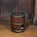 A George III mahogany and brass bound peat bucket, of cylindrical form, fitted a drawer to the lower