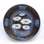 David Frith (b.1943) at Brookhouse Pottery charger with iron glaze and floral decoration,