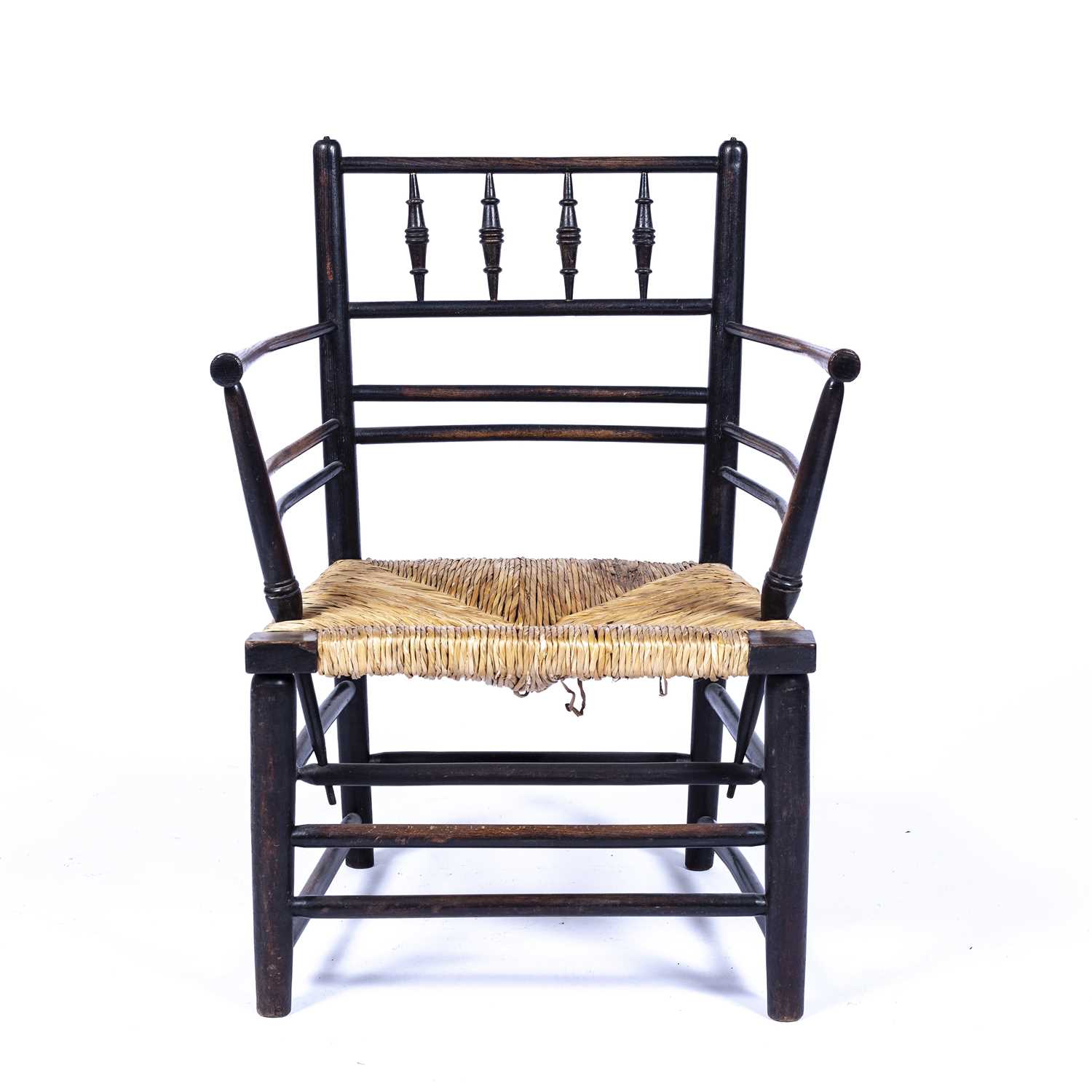 In the manner of Morris & Co 'Sussex' chair, ebonised with rush seat, unmarked, 74cm high