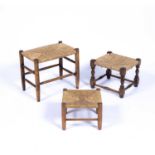 Cotswold School three rush seated stools, the largest oak example 47cm x 41cm x 30cm, the smaller