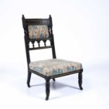 Aesthetic movement ebonised low chair, with William Morris style upholstery, with gilt painted