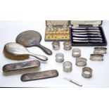 Collection of silver consisting of: silver mounted dressing table brushes, mirror, napkin rings,