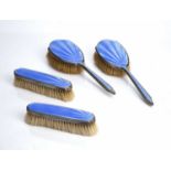 Set of four silver mounted dressing table brushes with blue guilloche enamel decoration, bearing