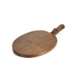 Robert Thompson of Kilburn (1876-1955) Mouseman cheese board, oak, carved mouse signature to handle,