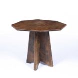 Wylie and Lochhead Ltd elm table, with hexagonal top, a plaque to the underside reading 'Wylie and