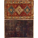 A Derband red, orange and blue ground rug with three central motifs, rosette designs and a banded