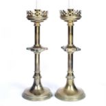 A pair of Victorian 'Gothic Revival' large brass candlesticks with pierced wax trays, hardstone