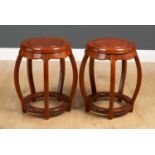 A pair of Chinese hardwood occasional tables or stools each of cylindrical form with pierced