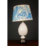 A white glazed pottery table lamp of pineapple form with a silver plated base, 58cm high to the
