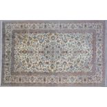 A Kashan cream ground rug with stylised vine leaf decoration, 300cm x 196cmCondition report: In good