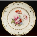 A 19th century Swansea porcelain plate, decorated with a central floral spray within relief