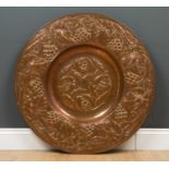 An arts and crafts large circular tray with fruit and fruiting vine hammered decorationCondition