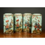 A set of four chinoiserie decorated storage tins with embossed and painted decoration of figures and