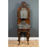 An 18th century French oak lavabo with pewter fountain and trough, the oak back with cartouche style