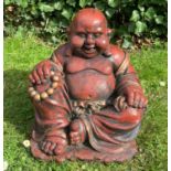 A Chinese red painted seated Buddha dressed in a gilt robe holding a set of beads, 35cm