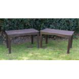A pair of brown painted hardwood garden tables on chamfered square supports, 122cm wide x 68cm