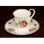 A Nantgawr porcelain teacup and saucer, 15.5cm diameter, with hand painted sprays of floral