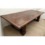 A large oak refectory table the rectangular plank top with cleated ends and on turned supports