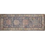 An antique Persian blue ground rug with geometric decoration. 114cm x 300cmCondition report: Dirty