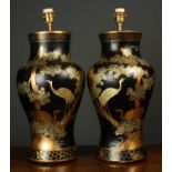 A pair of papier-mache chinoiserie table lamps with gilt exotic birds and animals amongst trees,