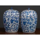A pair of modern Oriental porcelain jars of baluster form with a white ground and blue foliate