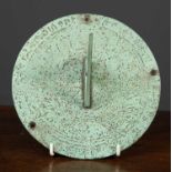 A modern green painted iron sundial plate marked with roman numerals and engraved with an
