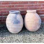 A near pair of antique Mediterranean terracotta round bottomed storage jars each approximately