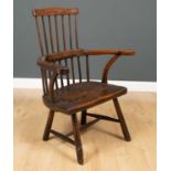 A late 18th century primitive elm comb back Windsor armchair, 63cm wide at the arms x 52cm deep x