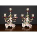 A pair of 19th century continental candelabras marked KPM to the base, each extensively decorated