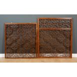 An Oriental softwood window screen with geometric decoration, 111cm wide x 131.5cm high and a