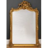 A 19th century gilt gesso moulded wall mirror with rocaille scroll crest to the arching top, and