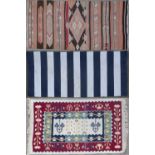 An Eastern flat weave striped rug 80cm x 169cm together with two further modern rugs of similar