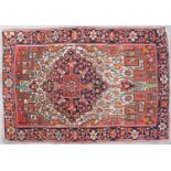 An early 20th century Persian Saruk rug with red, orange and blue ground with stylised foliate