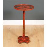 A late 19th century chinoiserie wine table with circular top and turned column support and