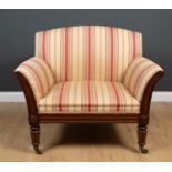 A William IV chair with mahogany frame, on tapering octagonal legs, the scrolling arms with