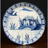 A rare London delftware teapot stand, c.1720, decorated with a building on an island and a