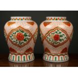 A pair of Chinese baluster vases with floral and foliate panels, surrounded by stylised floral