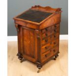 A William IV rosewood davenport with carved galleried top, the fall front with tooled leather