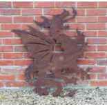 A pierced steel panel depicting a Welsh dragon, with forked tongue and pointed tail, 96cm wide x 0.