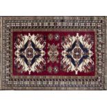 An Eastern red ground rug with geometric decoration within a banded border, 160cm x 221cmCondition