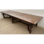 A large oak country house refectory table, the plank top with central diamond section inlaid, all on