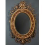 A 19th century Adam's style oval pier glass or mirror with ribbon tied foliate crest, the oval