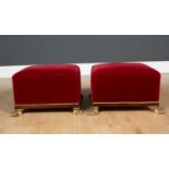 A pair of red upholstered square Victorian footstool with brass brocade, on brass paw feet, 33cm