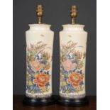 A pair of satsuma style cylindrical ceramic table lamps with flower decoration on turned black