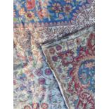 A Kashmiri chainstitch tapestry rug or wall hanging the all over floral decoration on white ground