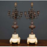 A pair of 19th century metal five branch candelabra on Carrara marble bases, the top candle sconce