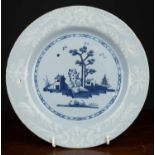 An 18th century English bianco sopra bianco delftware plate, the blue ground with central blue