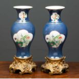 A pair of 18th century Chinese porcelain vases on gilt metal mounts, the blue ground with white